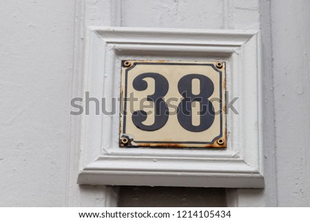 House number thirty-eight 38 in weathered and rusty metal painted cream and black from Västra Götaland County, Kungälv Municipality, Kungälv