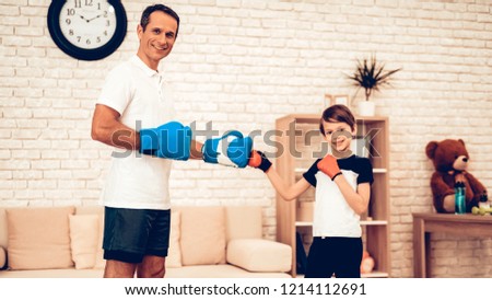 Boy Standing. Father and Son Boxer. Sport at Home. Warm Up in Quarter. Boxing Gloves. Doing Sports. Man and Boy Train at Home. Child in Boxing Gloves in Apartment. Little Boy.