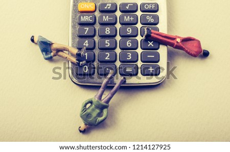 Men figurine on Calculator device  with a keyboard and display