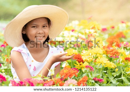 Young girl relax and study about flowers in the garden. She is enjoy with nature. Education concept. Soft focus and blur background.
