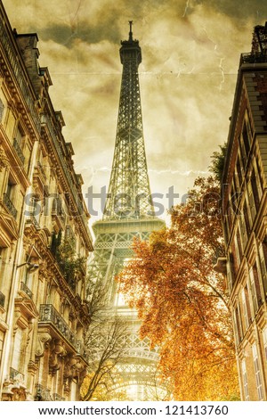 vintage style picture with a view on the Eiffel Tower in Paris between city buildings