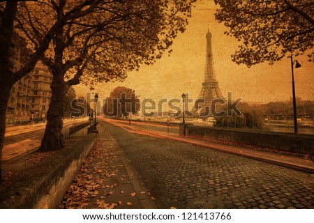 vintage style picture of Paris at dusk with a street along the Seine and the Eiffel Tower in the background Royalty-Free Stock Photo #121413766