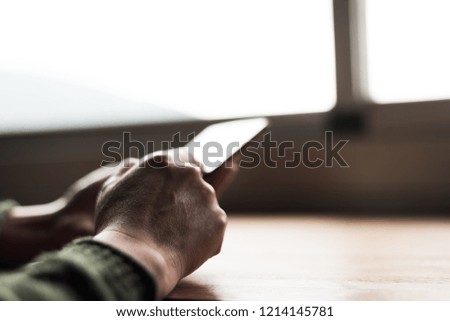 woman using smartphone, close-up image with hand