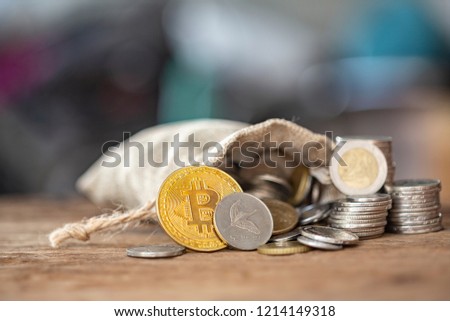 Crypto virtual currency Business finance concept, Close Up Shoot Of Golden Bitcoin and US dollar oins lay on beutiful real wooden plank.