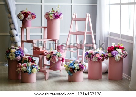 Interior of studio room with colorful fake flower handcraft from cloth in beige vases for decoration. Studio shot. Royalty-Free Stock Photo #1214152126