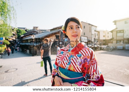 tourist visiting Japanese town with kimono. foreigner photographer in the background is taking picture by dslr camera. many travelers having japan travel in summer.