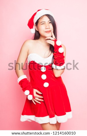 Cute Asian Christmas Santa Claus girl on pink background