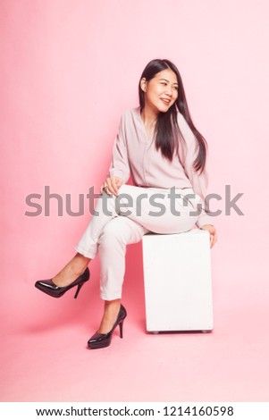 Beautiful young Asian woman in pink shirt on pink background