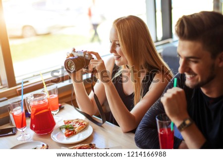 Attractive guys and girls drinking, eating pizza, shooting all the fun while dining at home