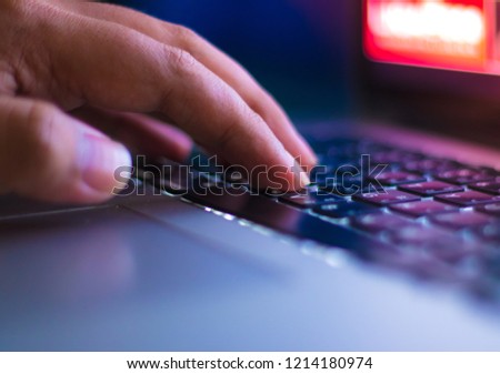 Human hand working on laptop