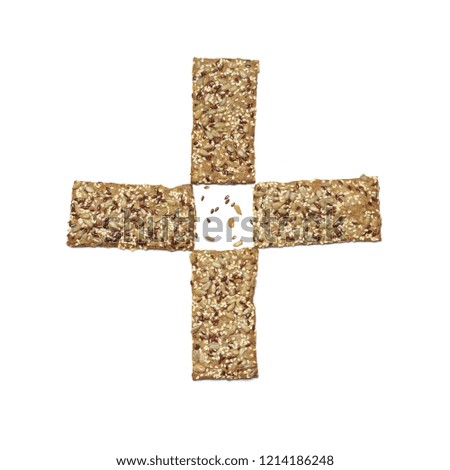 Cross shaped rye flatbread crackers with sesame and sunflower seeds isolated on white background. Top view point. Healthy food concept.