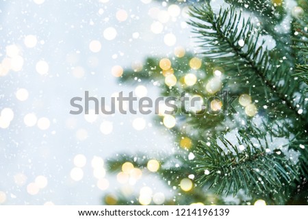 Closeup of Christmas tree with light, snow flake. Christmas and New Year holiday background. vintage color tone. Royalty-Free Stock Photo #1214196139