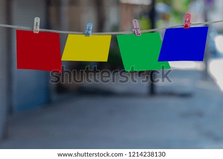 Pegs with paper hanging on the rope