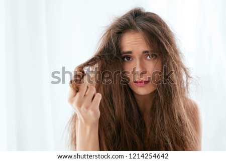 Hair Problem. Woman With Dry And Damaged Long Hair Royalty-Free Stock Photo #1214254642