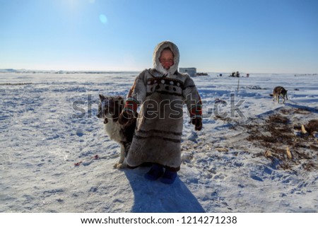 tundra, open area, the boy with a dog in cold winter weather, the boy  in national clothes,