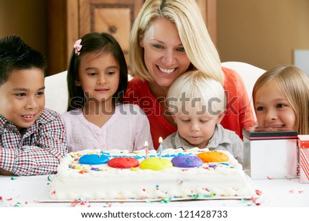 Mother Celebrating Child's Birthday With Friends