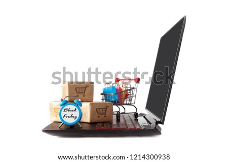 online shopping / e-commerce sale and delivery service concept, discounts, black Friday, sale: shopping cart multicolored packages and boxes with trolleybus logo on laptop keyboard isolated