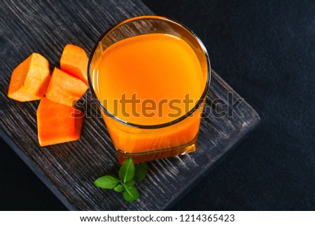 Pumpkin Smoothie Pumpkin juice on a dark table. Autumn drinks.