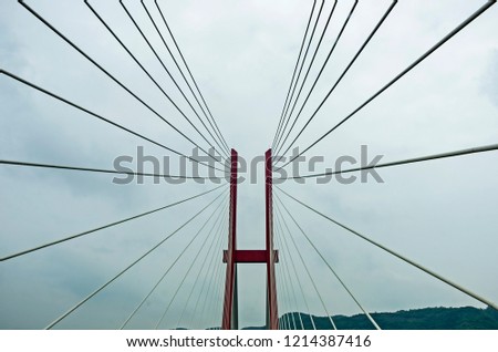 Modern bridge pylon against a blue sky Royalty-Free Stock Photo #1214387416