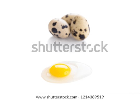 Organic quail eggs on the white background. Broken egg.