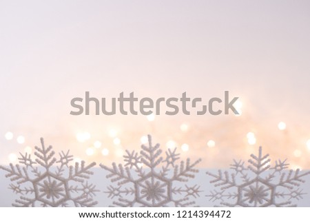 snowflakes row on blurry christmas lights background