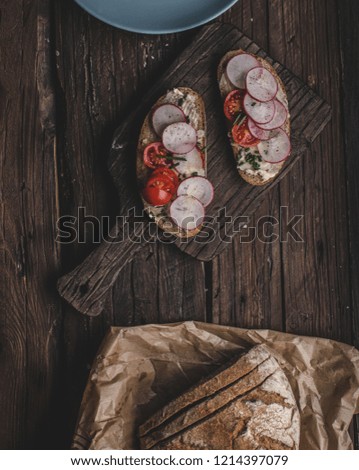 Homemade bread with fresh creame, herbs and radishes, organic food