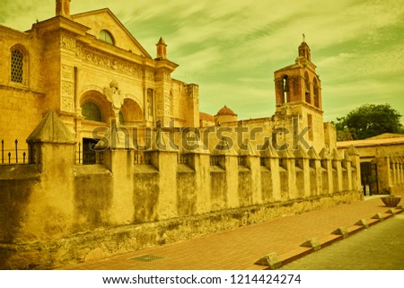 Vintage style photo of Side view of The Cathedral of Santa Maria la Menor in Colonial Zone of Santo Domingo capital of Dominican Republic. Photo is taken in sunny autumn day with small clouds the sky.