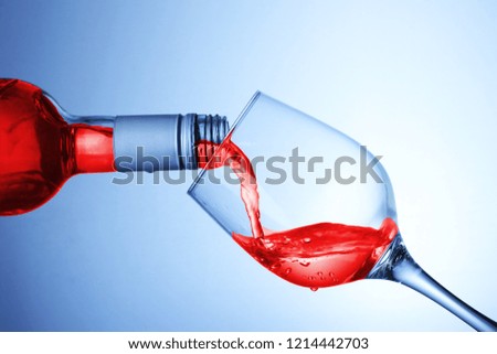 pouring wine into the goblet on a white background