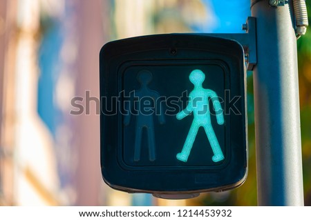 Traffic light on a city street, crosswalk green light