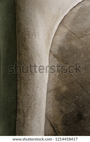 A close up detailed photo of a textured grayish beige construction made of granite, concrete and glass .