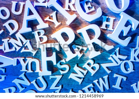 Alphabet. Latin letters scattered on a table. Wooden table covered with letters of the Latin alphabet.