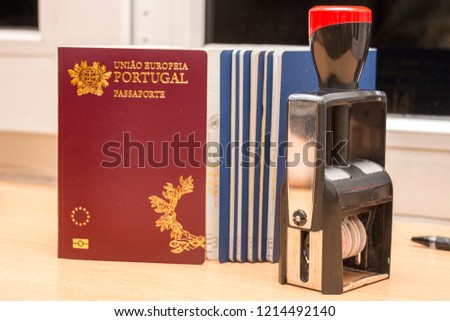 Close-up of a portuguese biometric passport and the datastamp during passport control at the border. Border crossing, travel, immigration concept Royalty-Free Stock Photo #1214492140