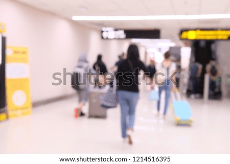 Travelers at airport terminal blur background with bokeh light filter.