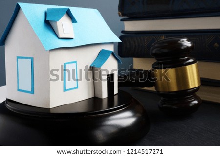 Real estate law. Model of house, gavel and books.