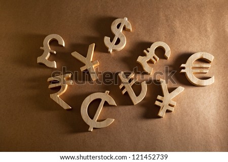 Wooden economy and currency unit on a craft background Royalty-Free Stock Photo #121452739