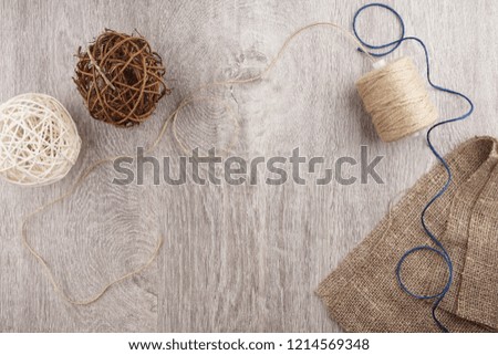 twine and two decorative balls on light gray wooden background