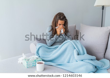 Cold And Flu. Portrait Of Ill Woman Caught Cold, Feeling Sick And Sneezing In Paper Wipe. Closeup Of Beautiful Unhealthy Girl Covered In Blanket Wiping Nose. Healthcare Concept. High Resolution Royalty-Free Stock Photo #1214603146