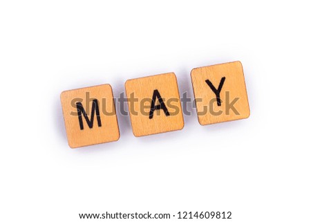 MAY, spelt with wooden letter tiles over a plain white background. 