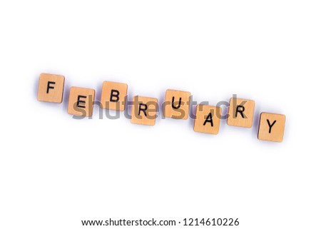 FEBRUARY, spelt with wooden letter tiles over a plain white background. 