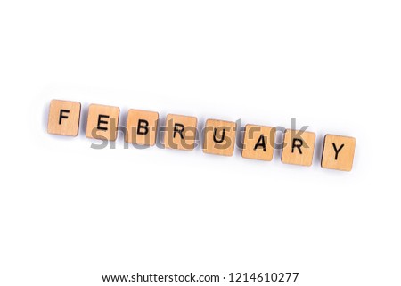 FEBRUARY, spelt with wooden letter tiles over a plain white background. 