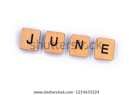 JUNE, spelt with wooden letter tiles over a plain white background. 