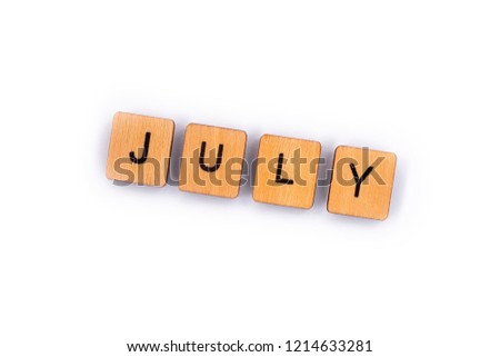 JULY, spelt with wooden letter tiles over a plain white background. 