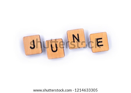 JUNE, spelt with wooden letter tiles over a plain white background. 