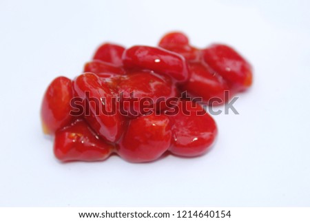 Fresh red colored large flat seeds of indian Momordica charantia ( bitter melon, bitter apple, bitter gourd, bitter squash, balsam-pear).isolated on white background, with copy space, food concept.