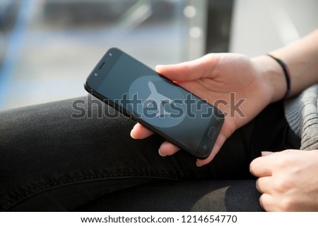 Hand setting the flight mode to the smartphone before taking off for security reasons Royalty-Free Stock Photo #1214654770