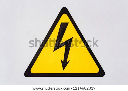 Sign of high voltage on a white metal