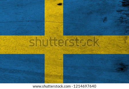 Flag of Sweden on wooden plate background. Grunge Sweden flag texture, it is consists of a yellow or gold Nordic Cross on a field of blue.