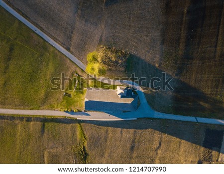 Aerial view of church on agriculture field in mountain valley in Switzerland, Europe