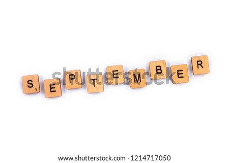 SEPTEMBER, spelt with wooden letter tiles over a plain white background. 