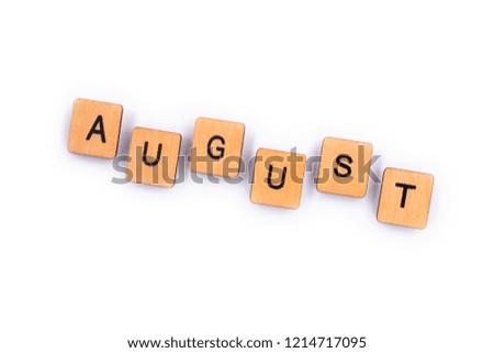 AUGUST, spelt with wooden letter tiles over a plain white background. 